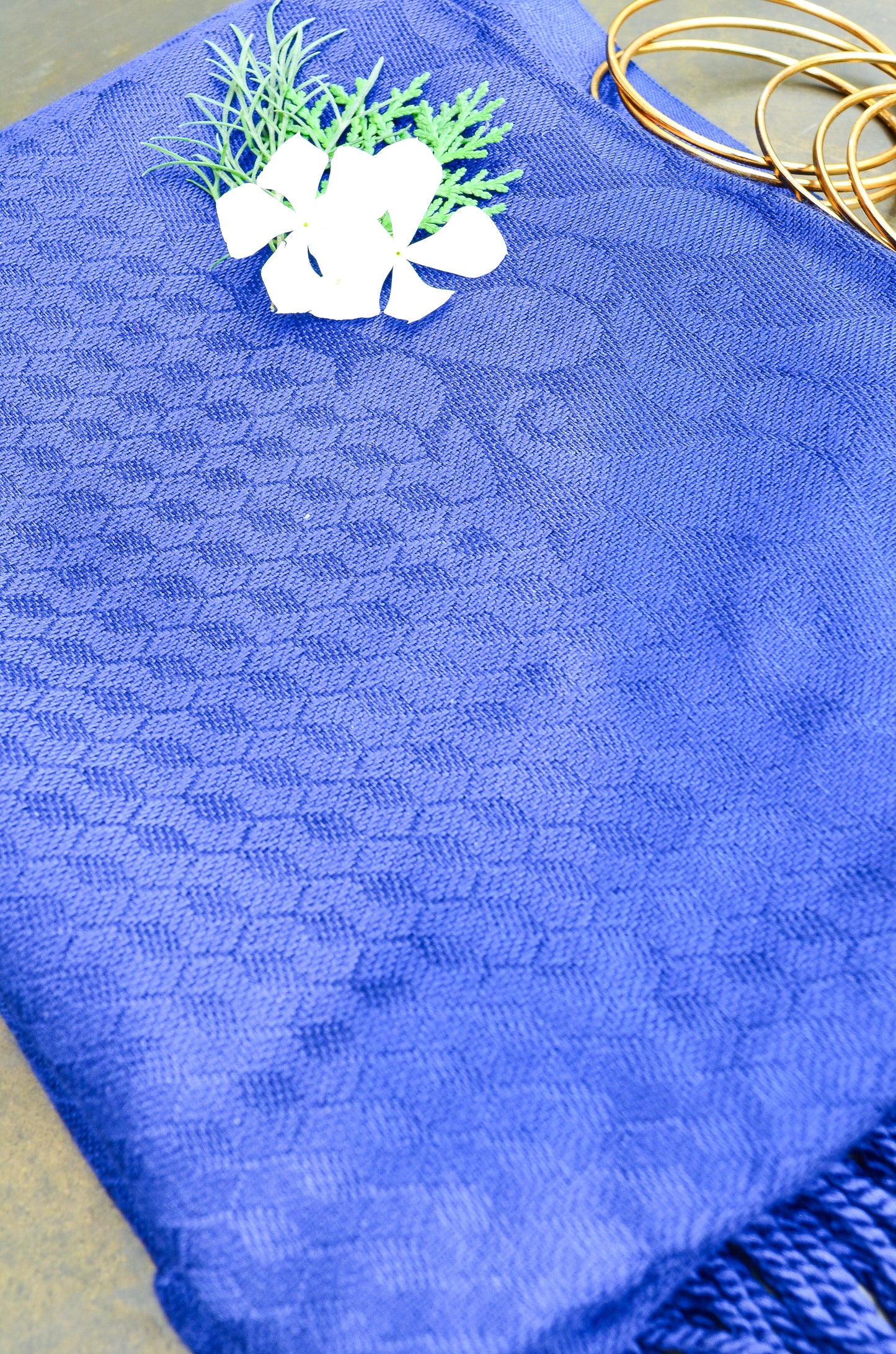 Elegant blue jacquard stole with textured pattern, perfect for versatile styling and warmth