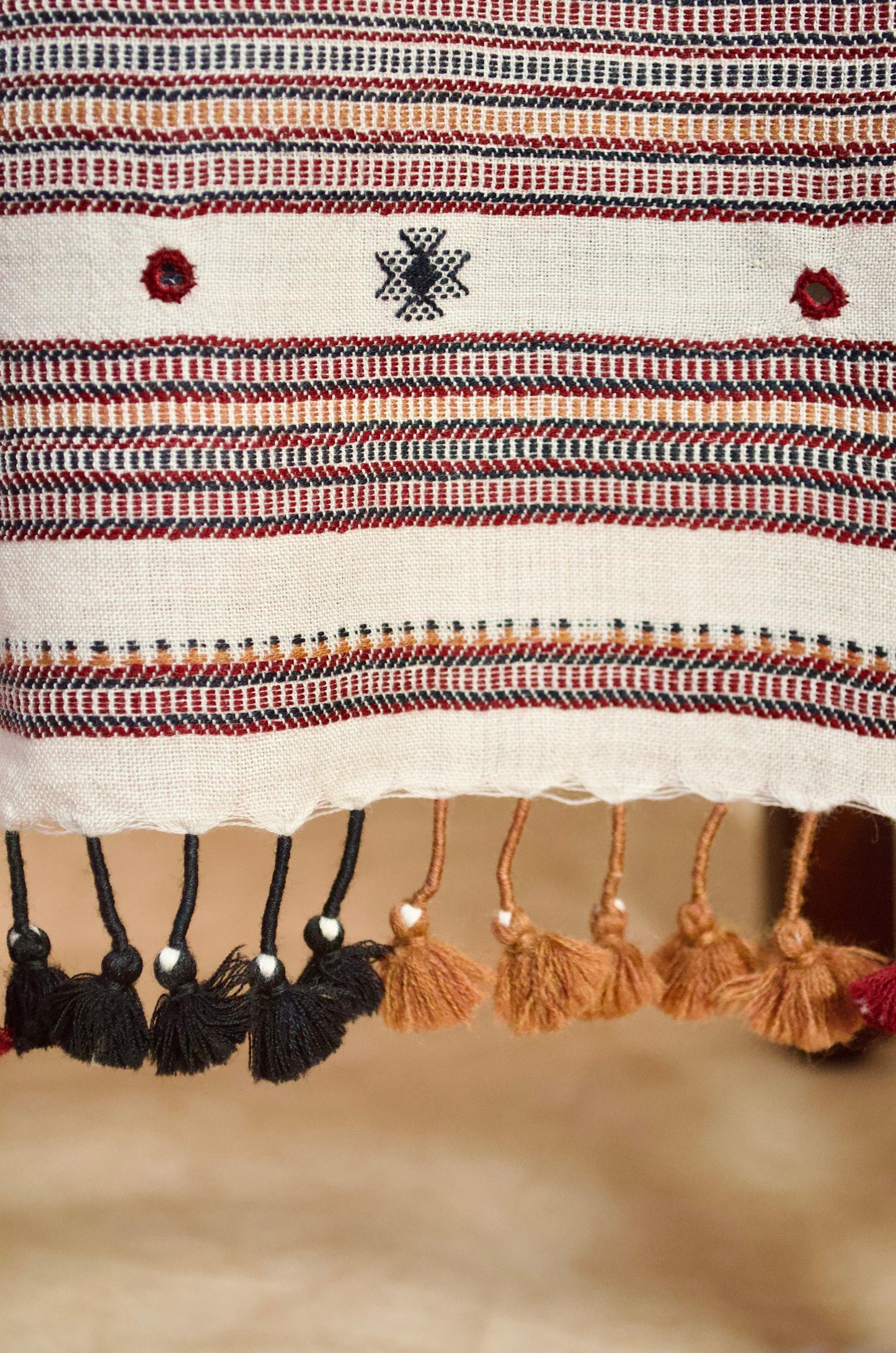 Hand woven merino wool stole with intricate patterns and colorful tassels for elegant styling