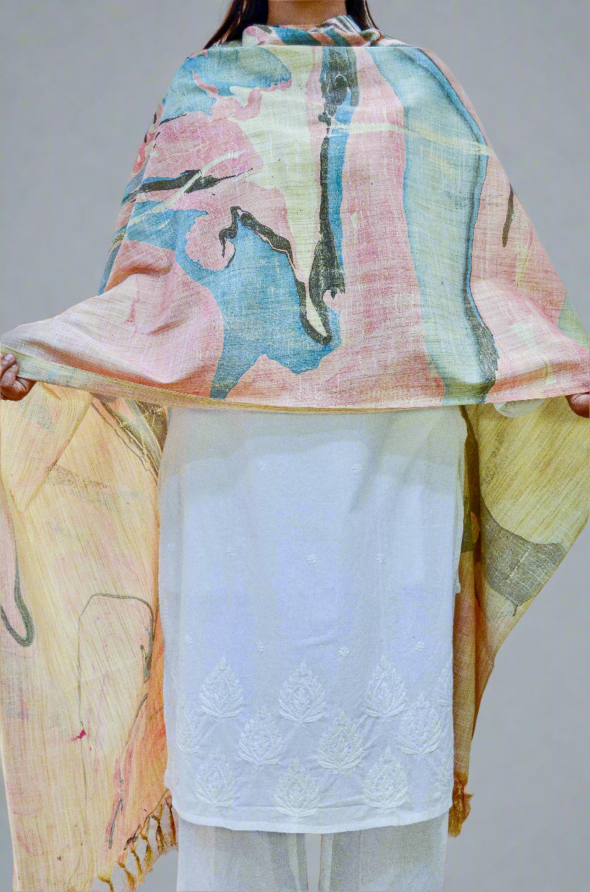 Handwoven cotton marble printed dupatta in soft pastel colors draped elegantly over a white outfit