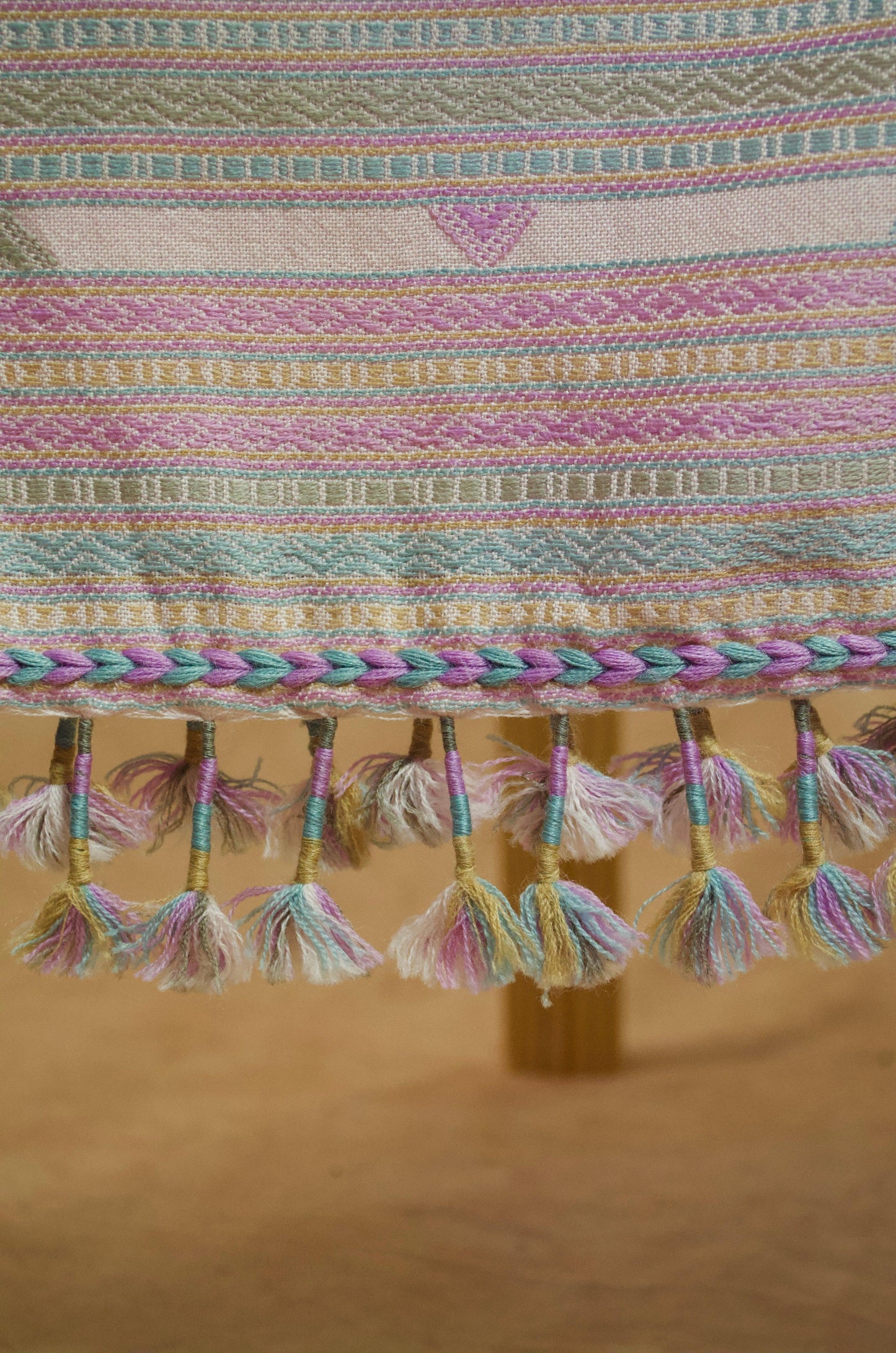 Handwoven merino wool silk shawl featuring colorful tassels and intricate patterns