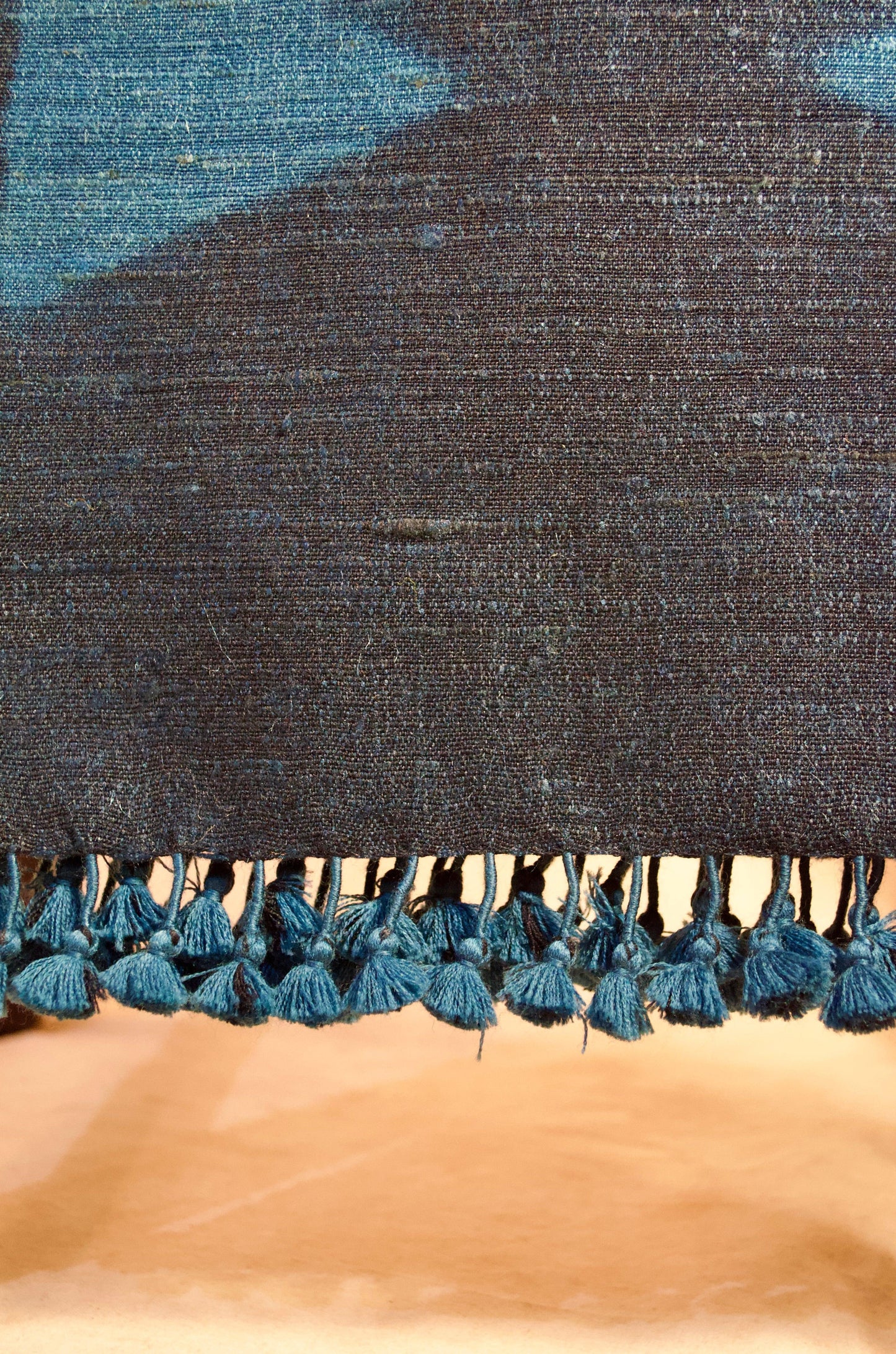 Handwoven merino wool stole with intricate patterns and decorative tassels for stylish warmth