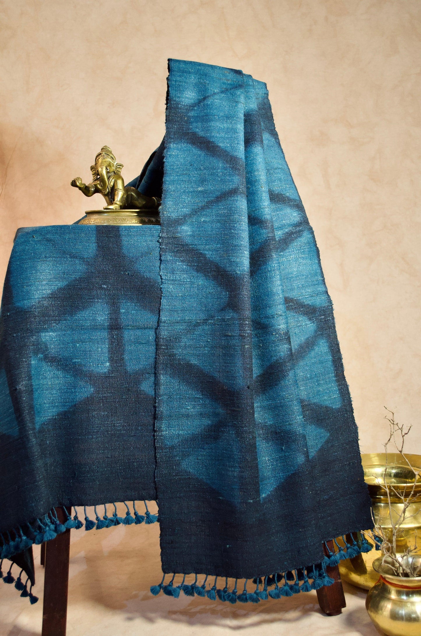Handwoven merino wool stole in blue with intricate geometric patterns and tassels for a stylish look
