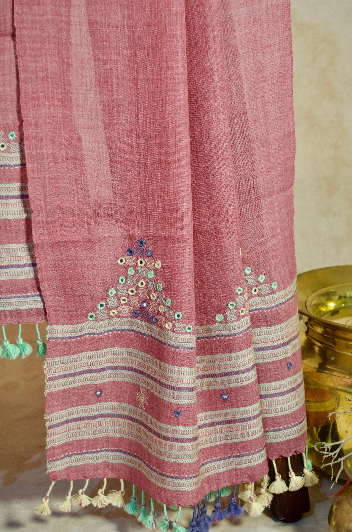 Handwoven merino wool stole in pink with decorative embroidery and tassels for a stylish look