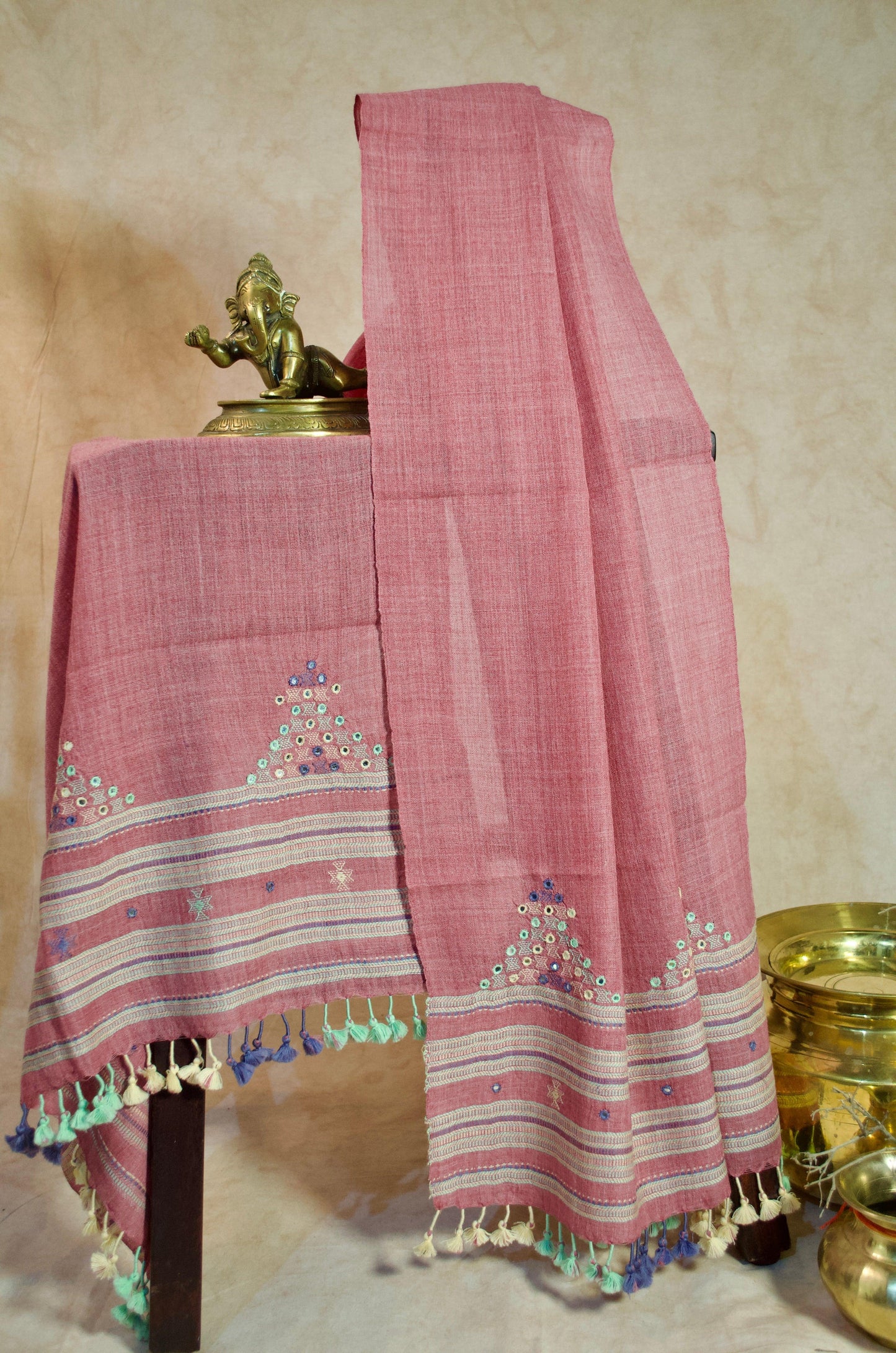 Handwoven merino wool stole with intricate embroidery and colorful tassels for elegant styling