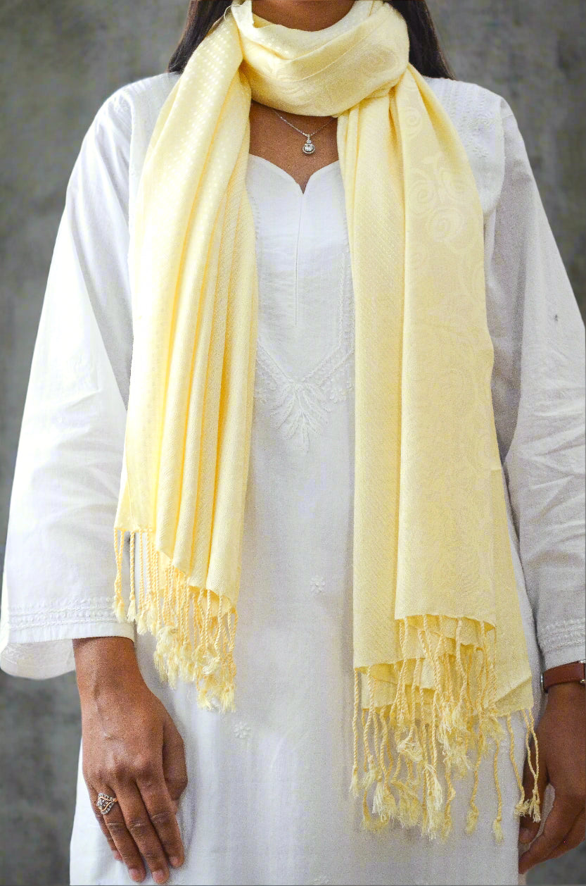 Elegant ivory jacquard stole with soft texture draped over a model for stylish layering