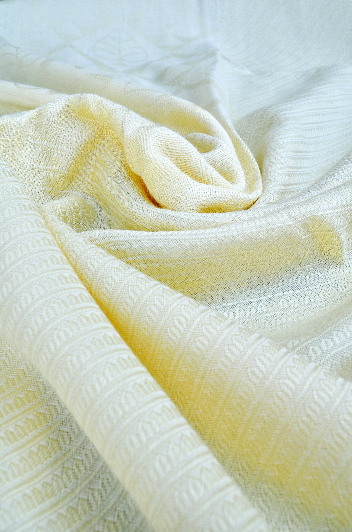 Elegant ivory jacquard stole featuring intricate patterns for a stylish layer