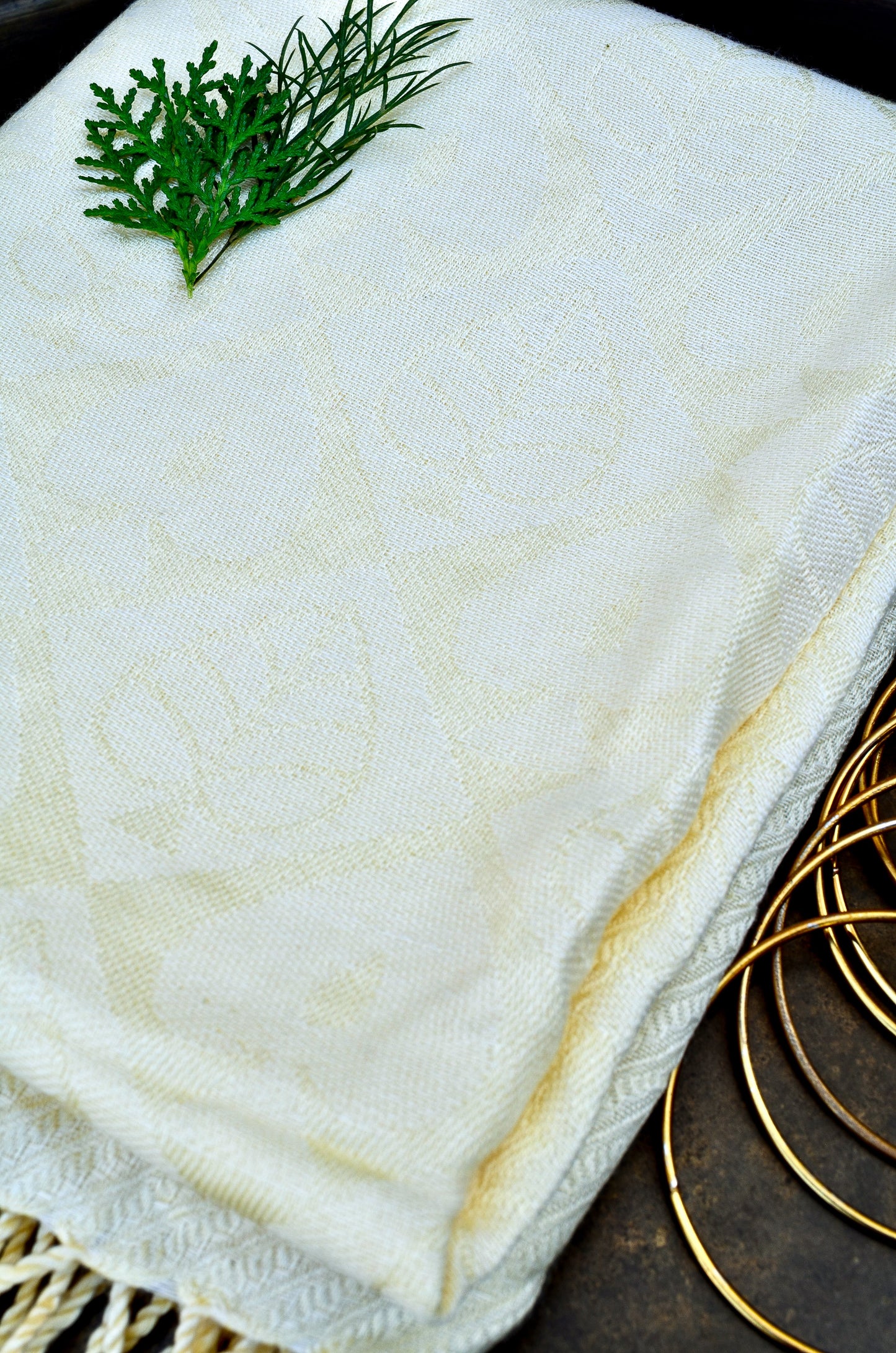 Ivory jacquard stole with delicate floral patterns and fringed edges for elegant styling