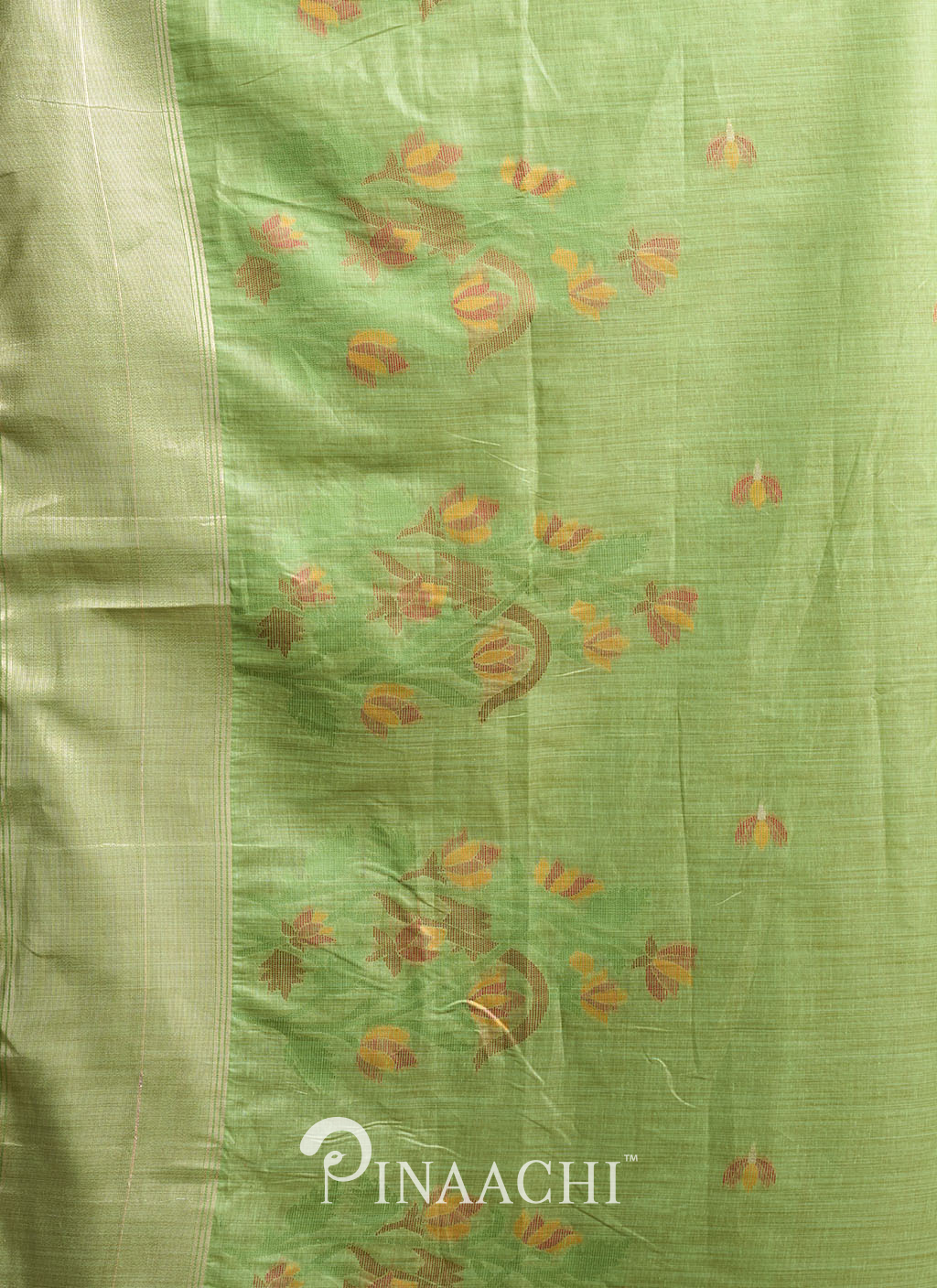 Pinaachi green jamdani saree with delicate floral motifs and subtle traditional weaving