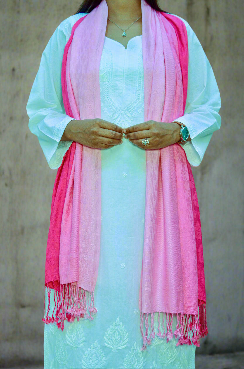 Light pink gradient jacquard stole draped elegantly over a white outfit, showcasing its soft textures