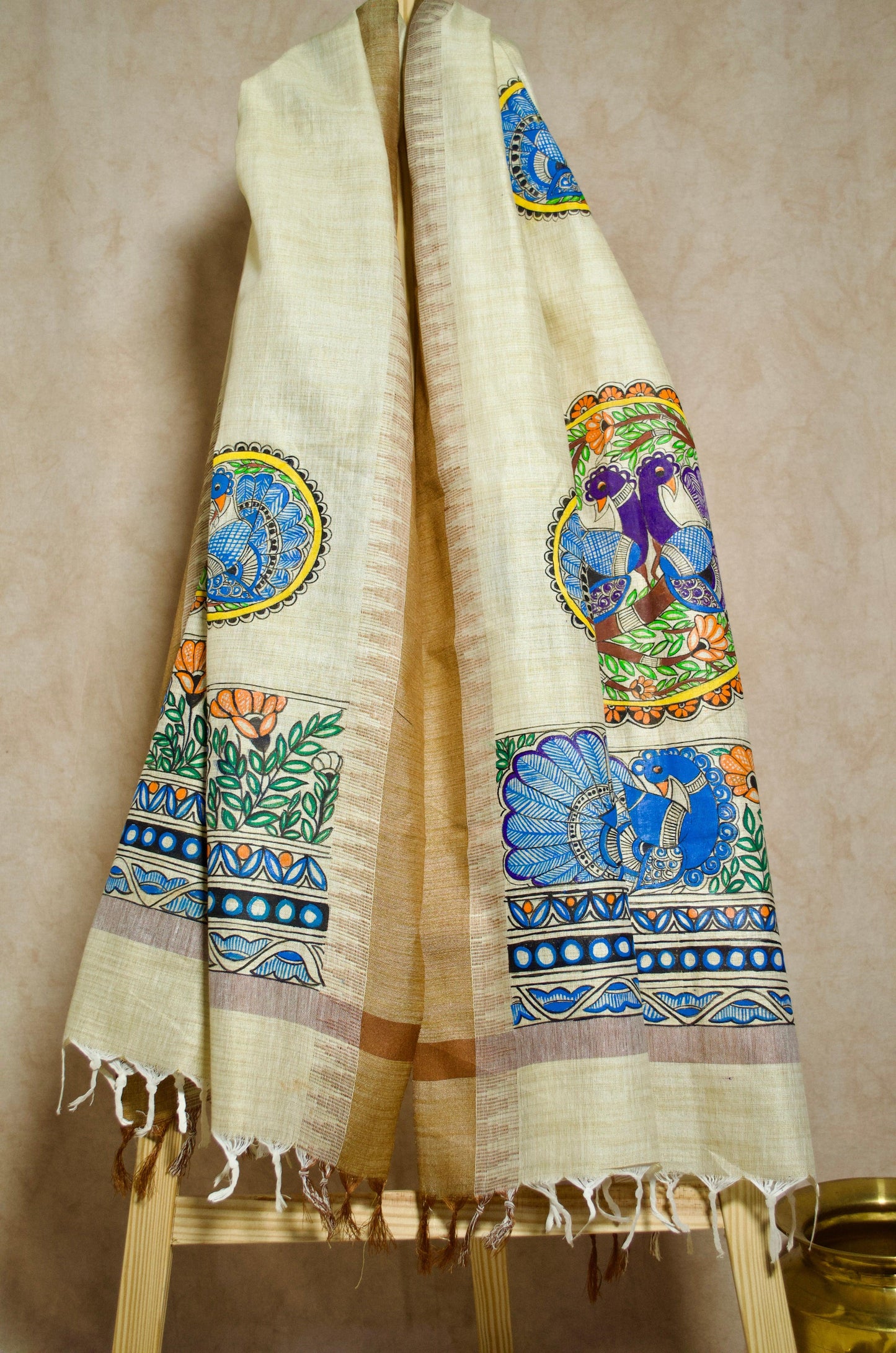 Madhubani hand painted dupatta displayed on a wooden stand, featuring vibrant colors and intricate designs
