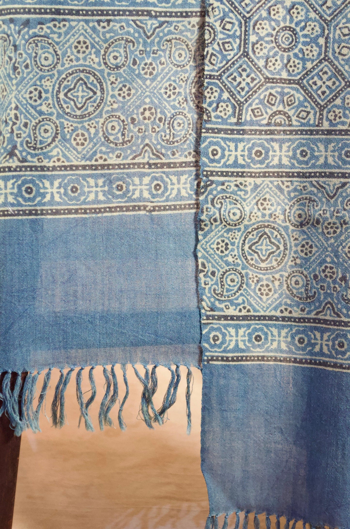 Merino wool Ajrakh stole in blue with intricate patterns and fringed edges for stylish layering