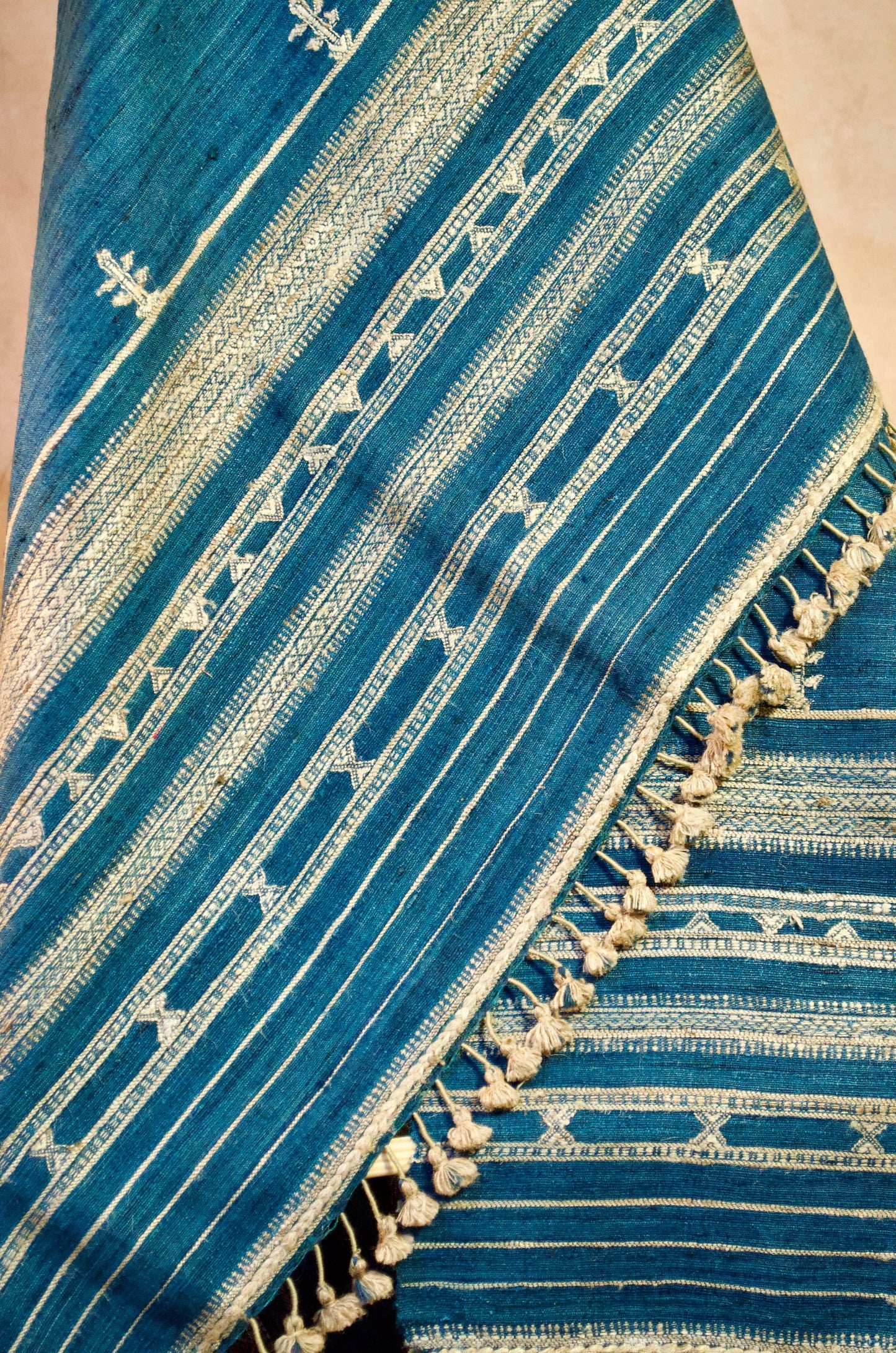Elegant merino wool indigo shawl with intricate patterns and tassels, perfect for stylish warmth.