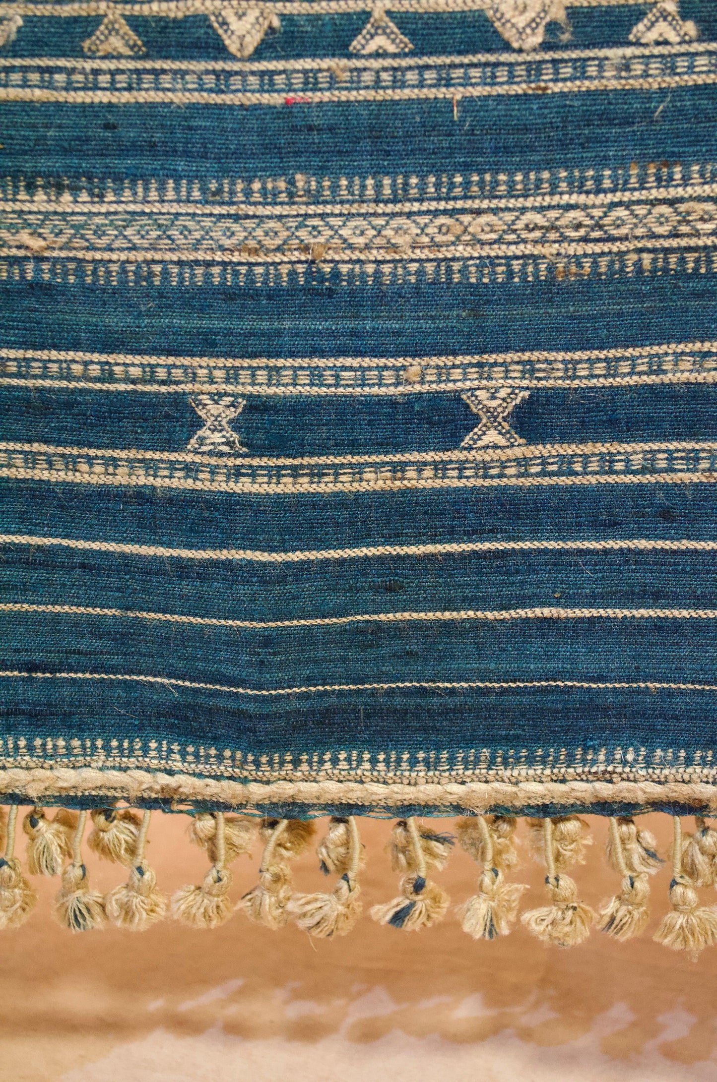Handcrafted merino wool indigo shawl with intricate patterns and elegant tassels