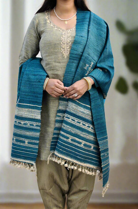 Elegant woman wearing a merino wool indigo shawl with intricate patterns, perfect for stylish layering