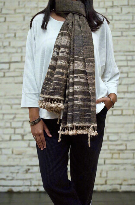 Stylish woman wearing a merino wool tasar silk stole in earthy tones with intricate patterns