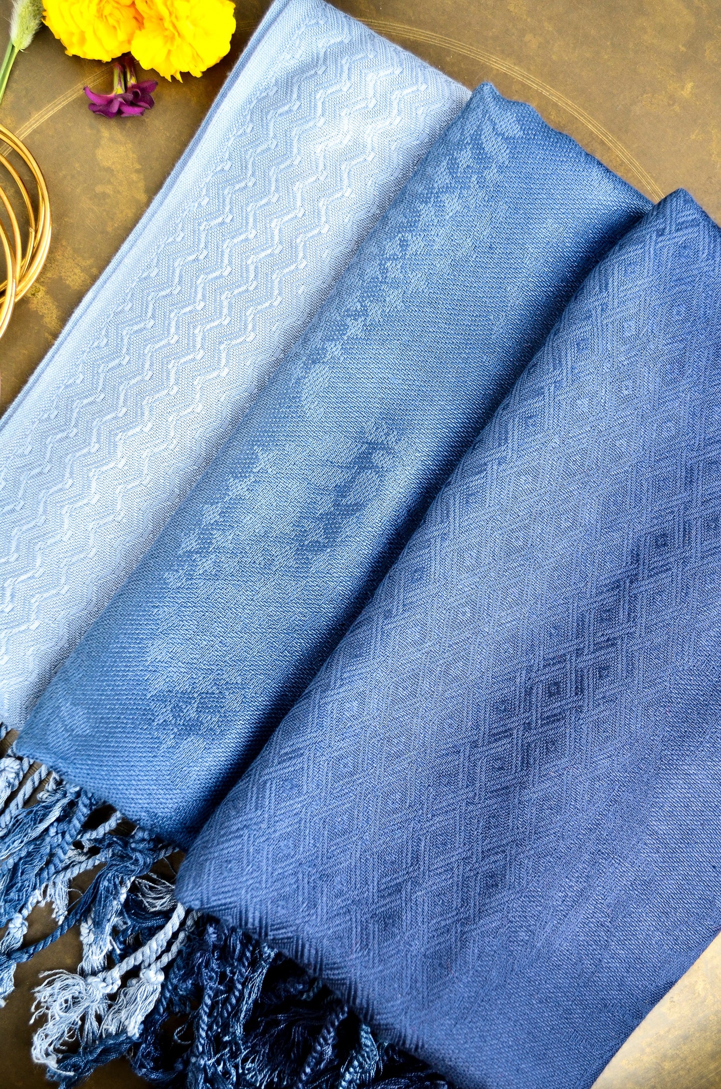 Elegant midnight blue jacquard stole with intricate patterns and fringed edges, perfect for stylish layering