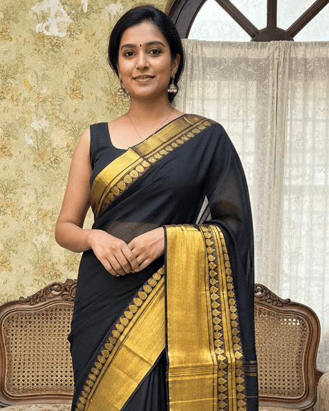Pinaachi black cotton saree with golden border and intricate detailing, perfect for festive occasions
