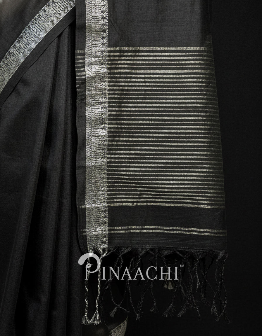 Elegant black mul tissue handloom saree with intricate silver border and fringed pallu