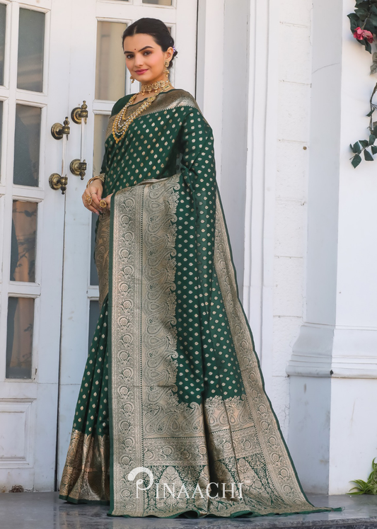 Elegant Pinaachi bottle green Banarasi saree with intricate gold patterns worn by a woman