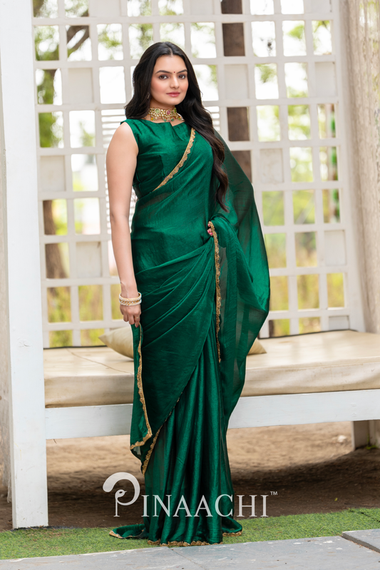 Woman wearing Pinaachi bottle green chiffon saree with golden border and matching blouse