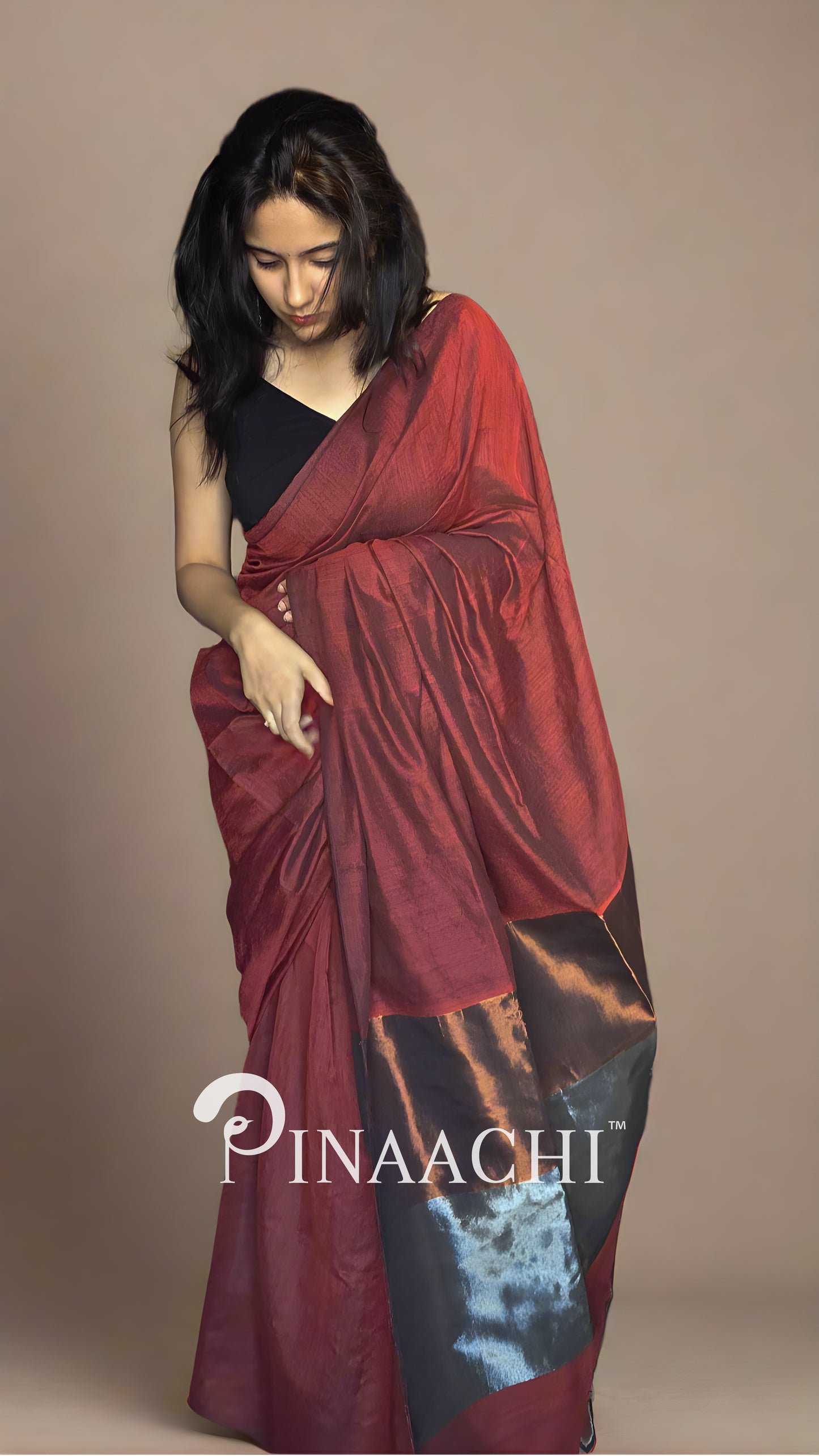 Elegant brick red cotton saree with zari draped stylishly for a classic look