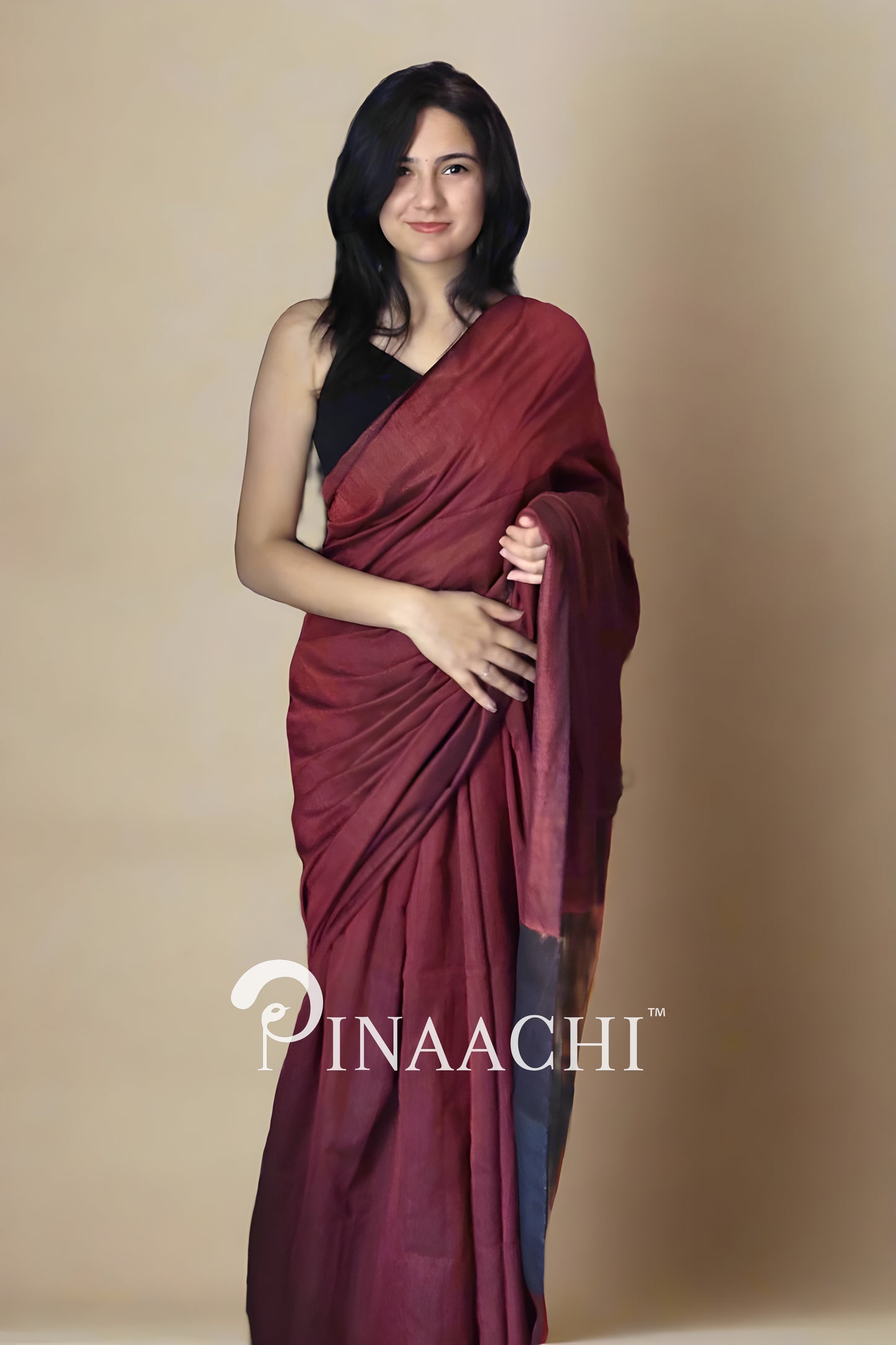 Elegant brick red cotton saree with zari, showcased by a model, perfect for festive occasions
