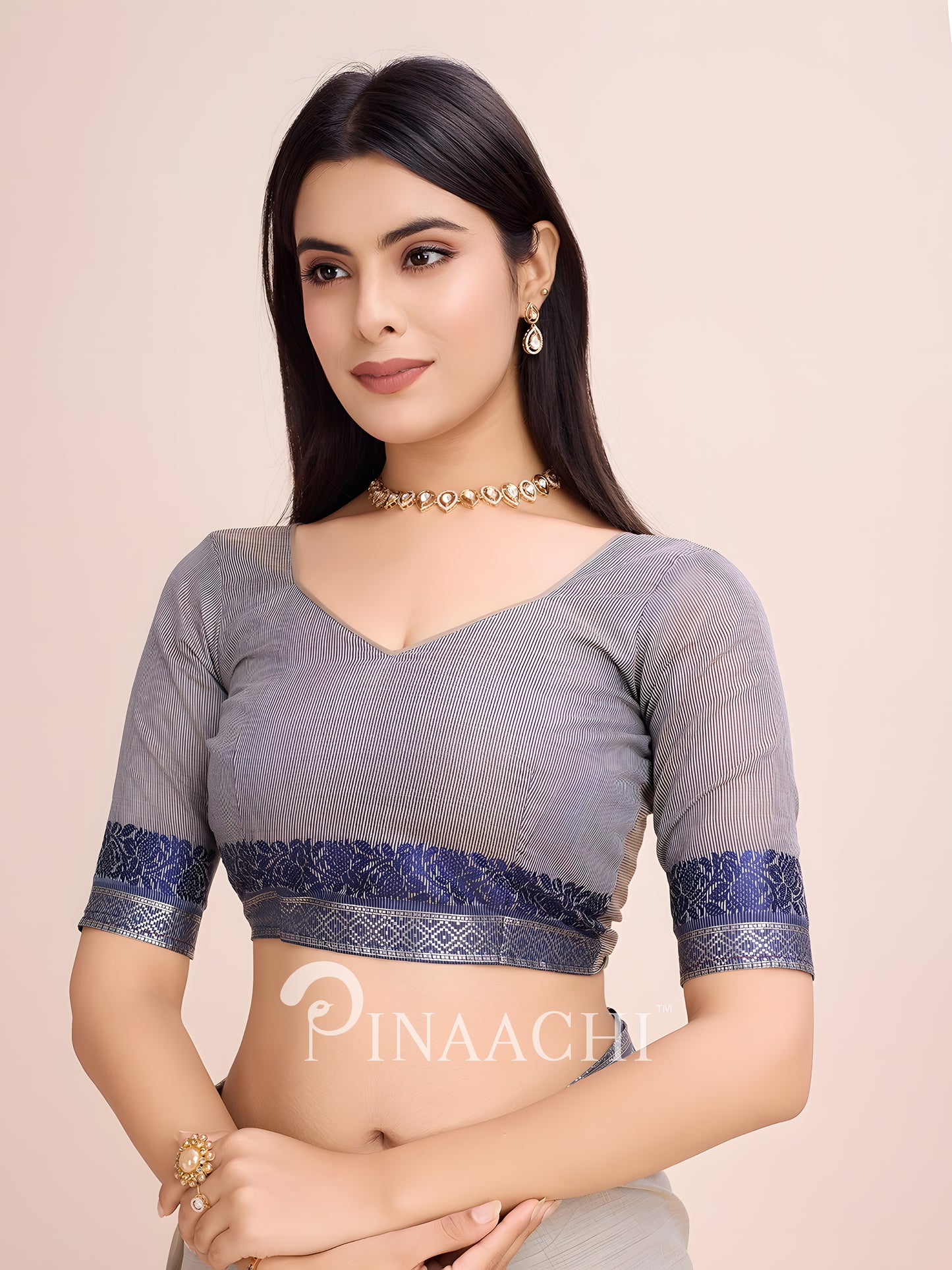 Dove grey cotton saree styled with an elegant blue embroidered blouse for a chic look