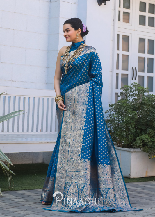Woman wearing Pinaachi Firozi Banarasi silk saree with intricate gold zari work and traditional jewelry