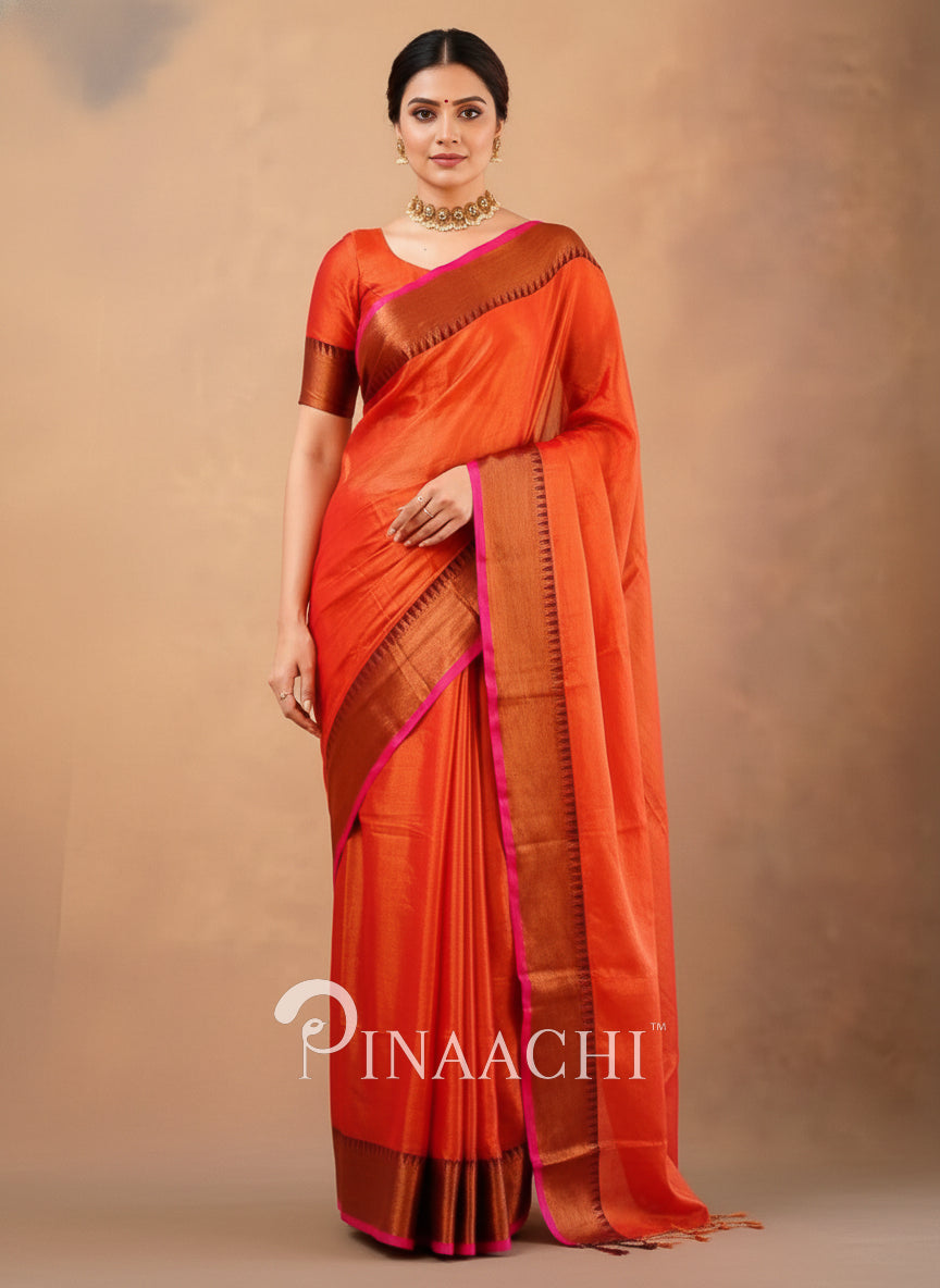 Elegant handloom orange red tissue silk saree draped on a model styled with traditional jewelry