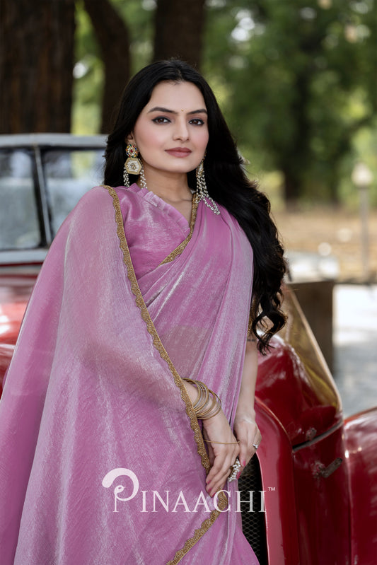 Elegant woman wearing Pinaachi lavender chiffon saree with gold border and statement earrings