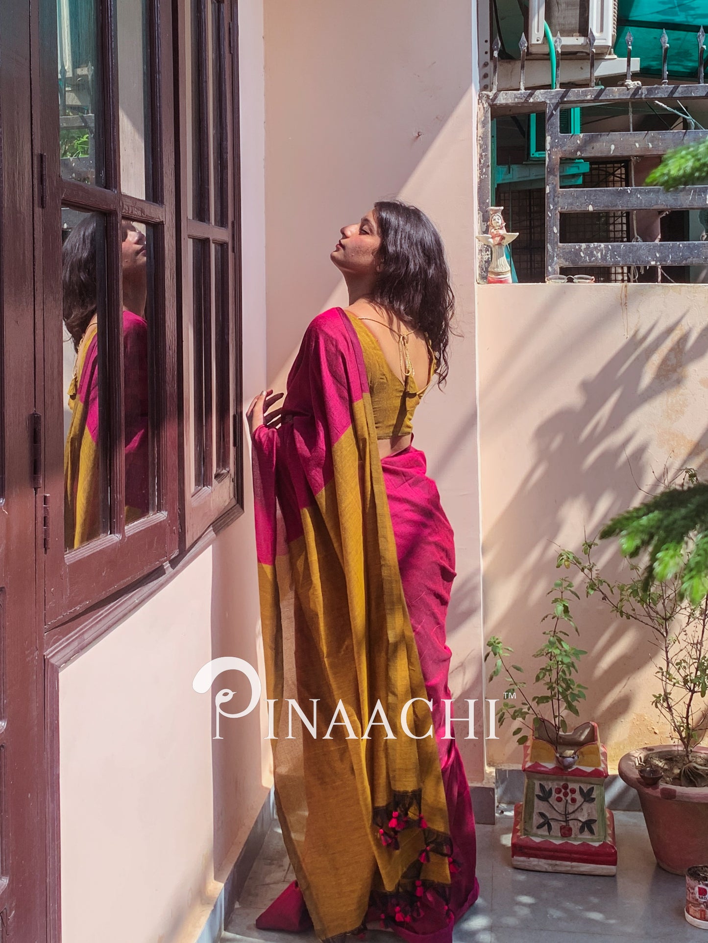 Elegant magenta pink cotton handloom saree draped stylishly, perfect for special occasions