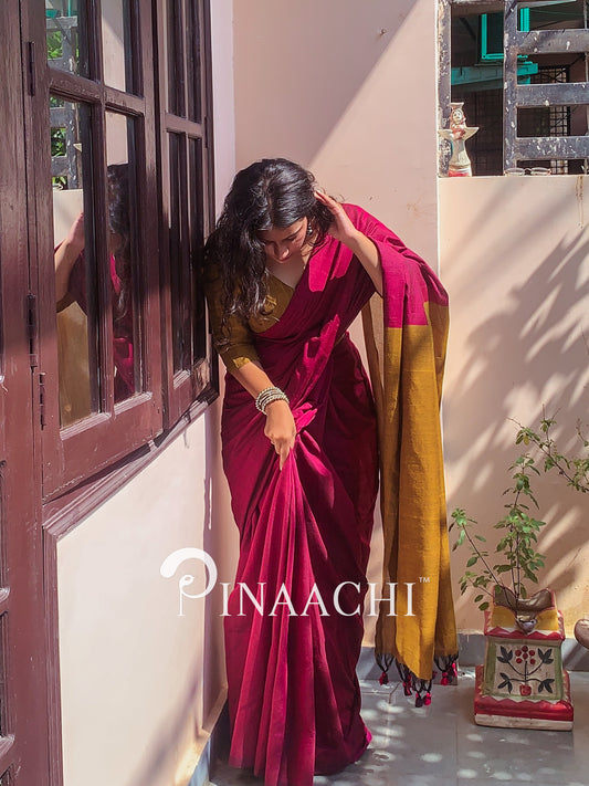 Elegant magenta pink cotton handloom saree draped beautifully with a contrasting border