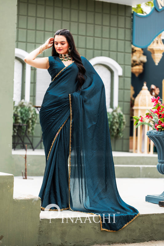 Woman wearing elegant blue Pinaachi Morpich chiffon saree with gold border outdoors
