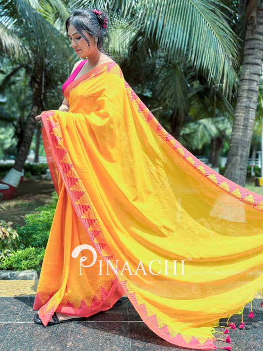 Mustard yellow cotton saree by Pinaachi with pink border and decorative tassels for elegant occasions