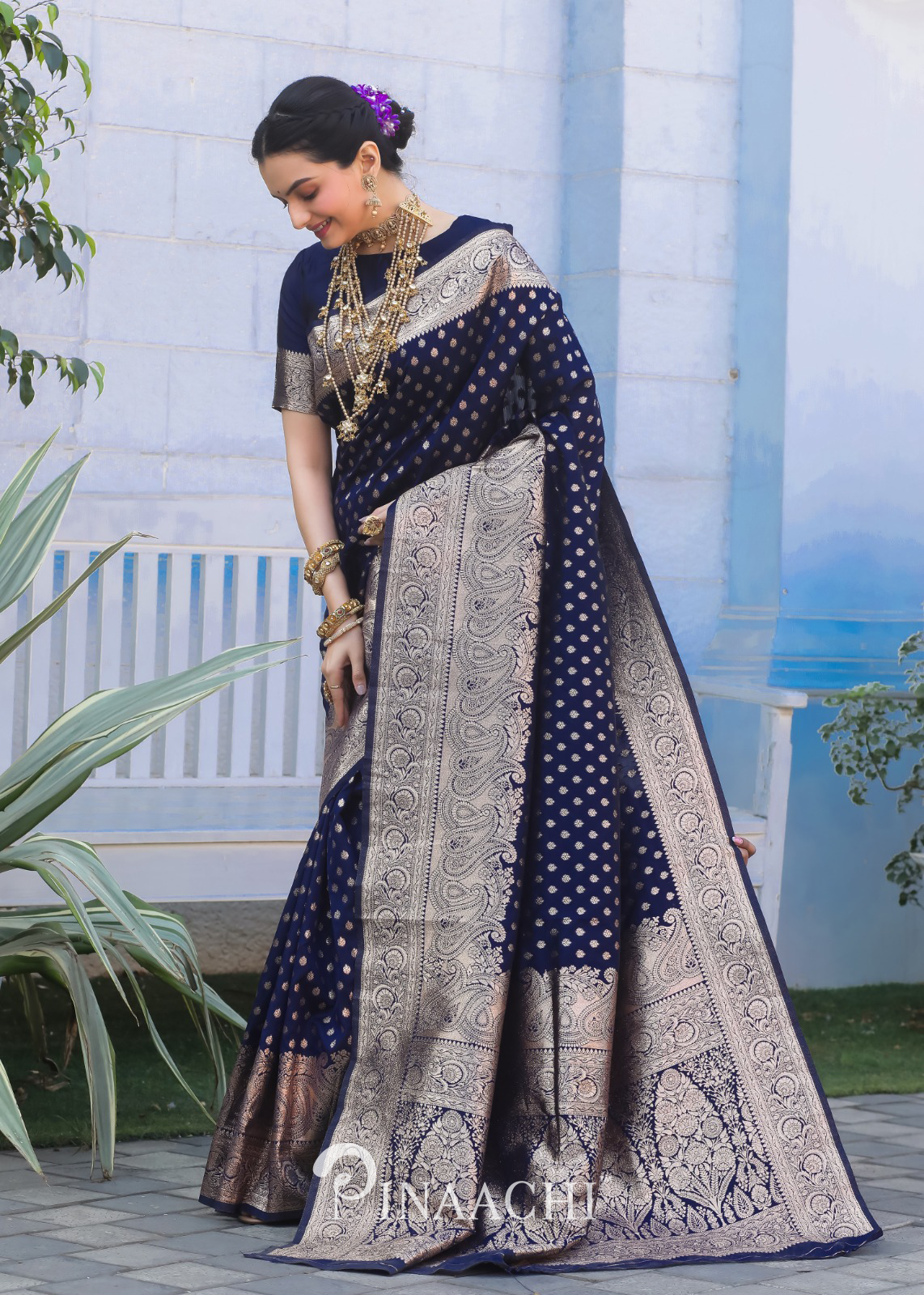 Pinaachi Navy Blue Banarasi Silk Saree worn by a woman with intricate silver zari work and traditional patterns