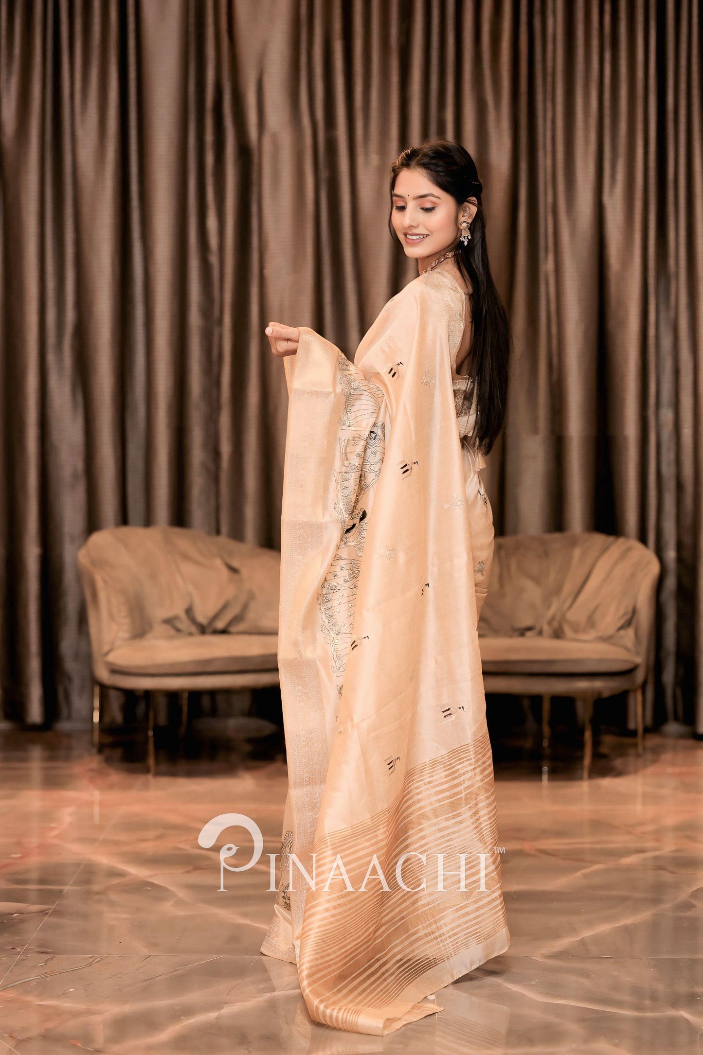 Elegant off-white tussar silk saree from Pinaachi, showcasing intricate designs and draping style