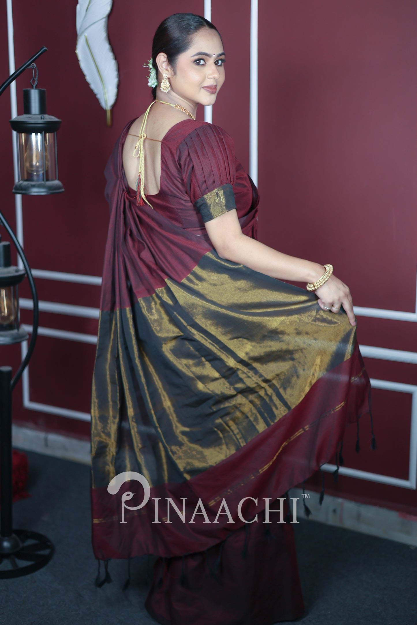 Elegant plum wine cotton saree handspun with intricate design, worn gracefully by a model
