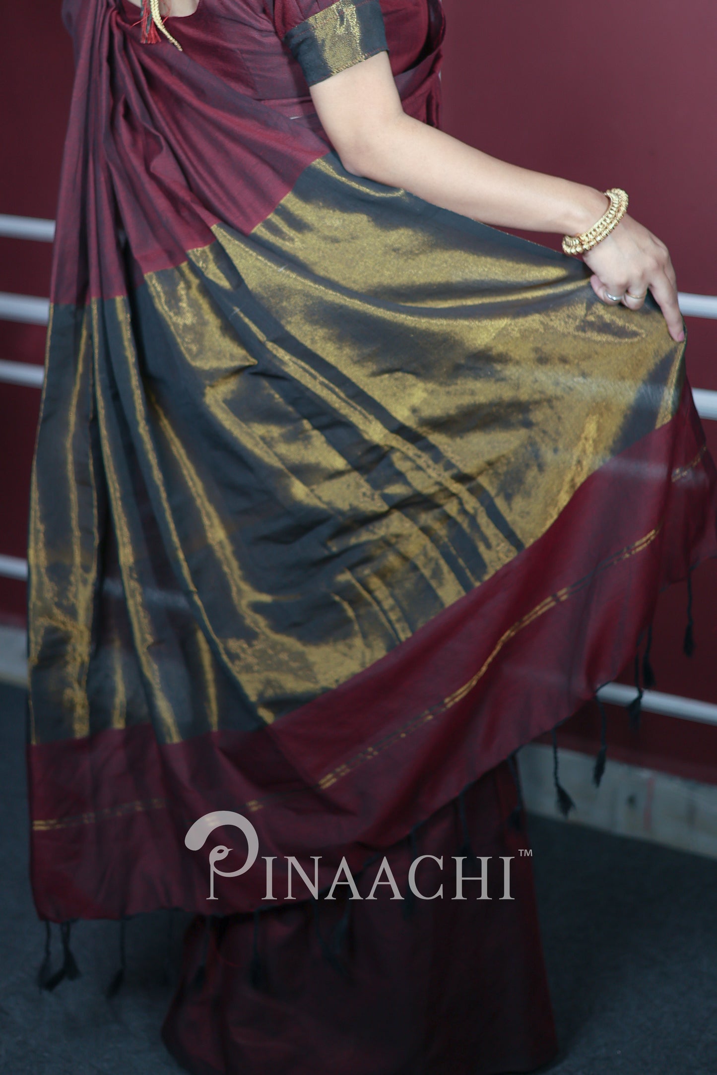 Plum wine cotton saree handspun with elegant gold accents and draping style by Pinaachi