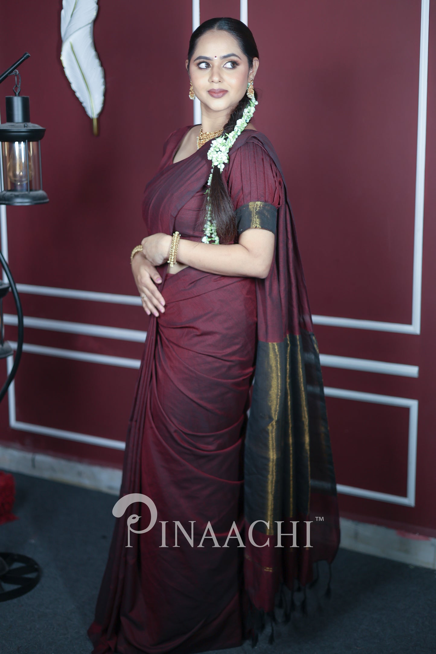 Elegant plum wine cotton saree handspun with contrasting black borders, perfect for special occasions