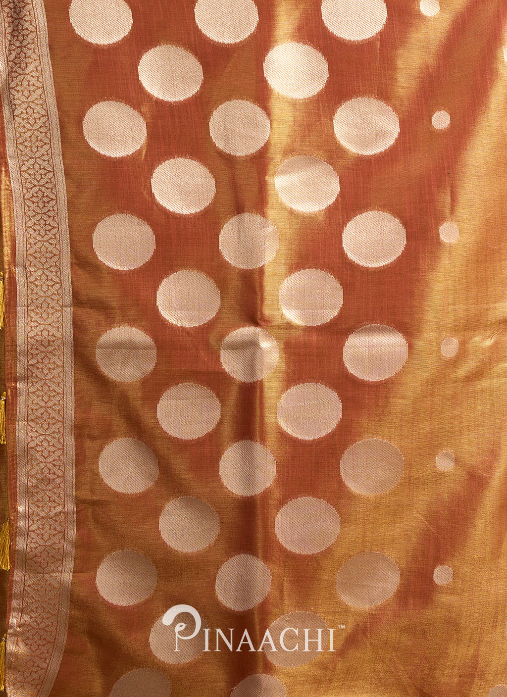 Pinaachi polka tissue silk saree in golden color with large white polka dots and intricate border design