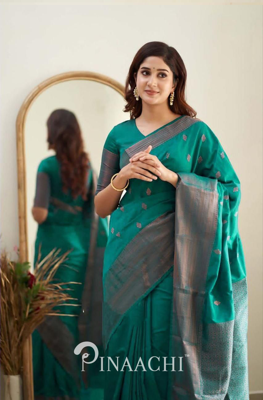 Pinaachi Rama Green Litchi Silk Saree worn by woman with traditional earrings and simple makeup