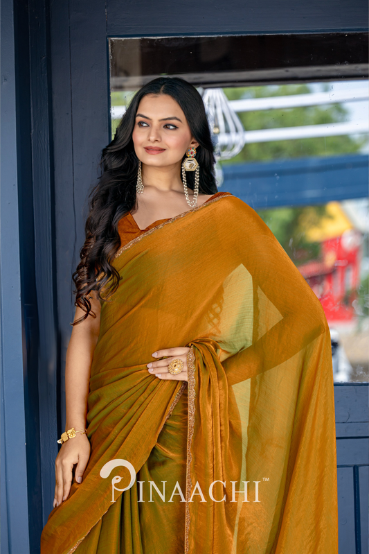 Woman wearing pinaachi solid gold chiffon saree with elegant drape and gold accents