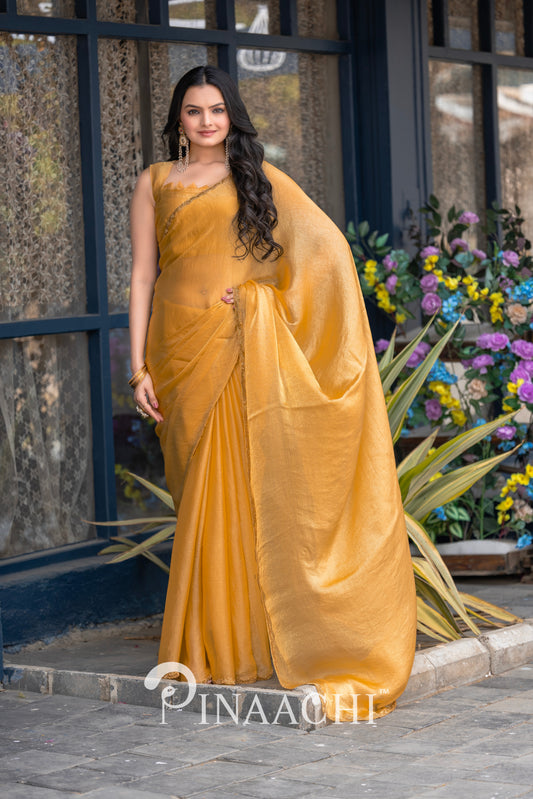 Elegant pinaachi solid yellow chiffon saree worn by model with floral background