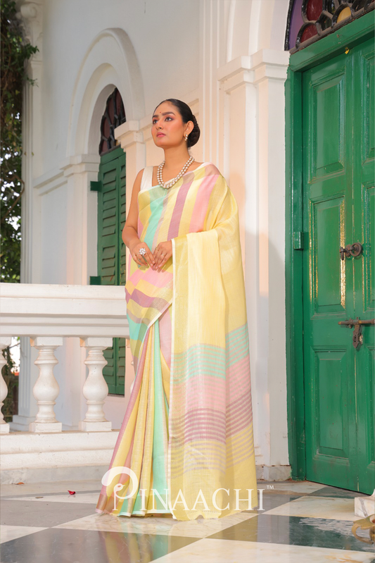 Woman wearing Pinaachi Summer Stripe Linen Silk Saree in pastel yellow, pink, and green stripes with elegant drape
