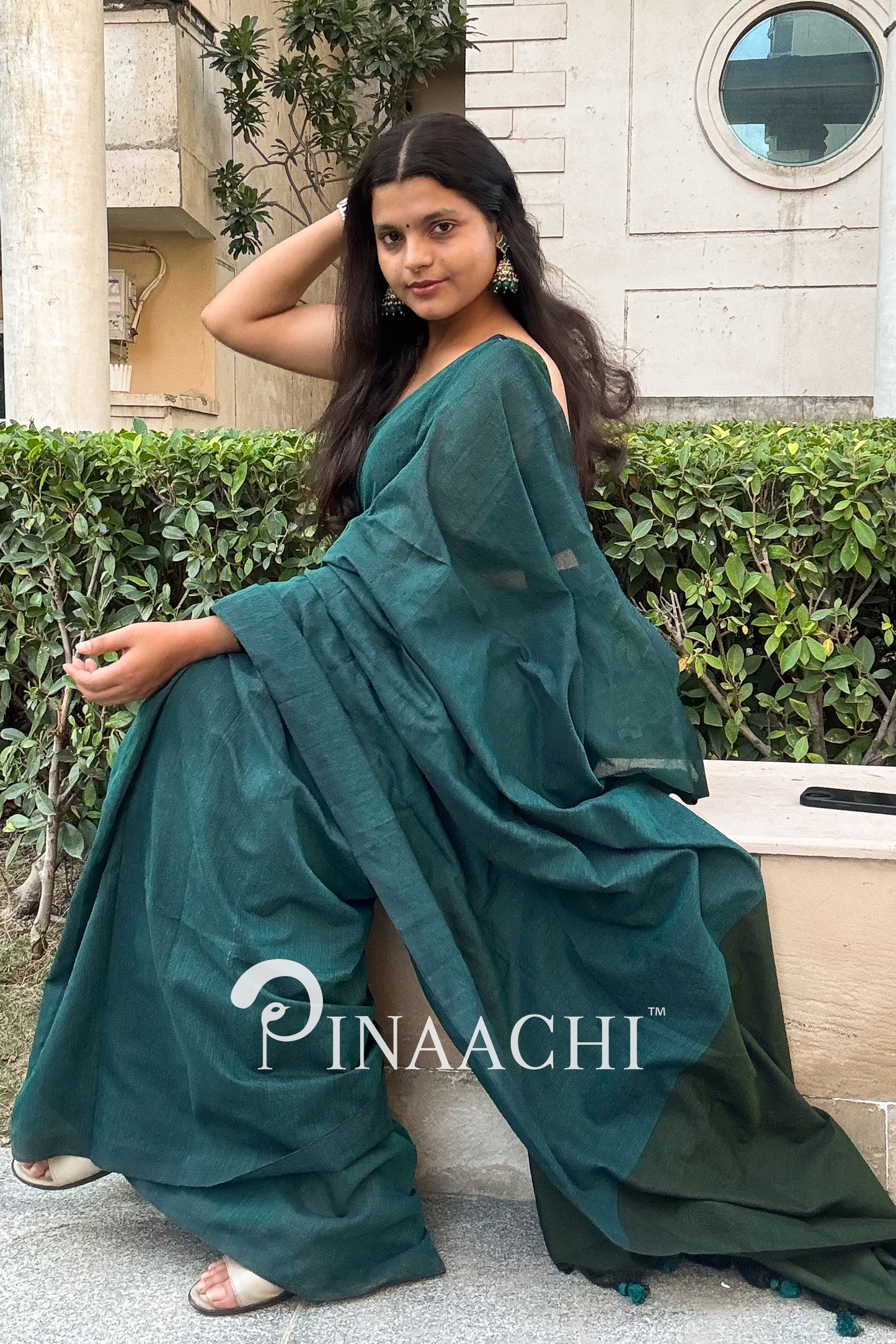 Elegant teal green cotton saree draped stylishly, perfect for casual and festive occasions