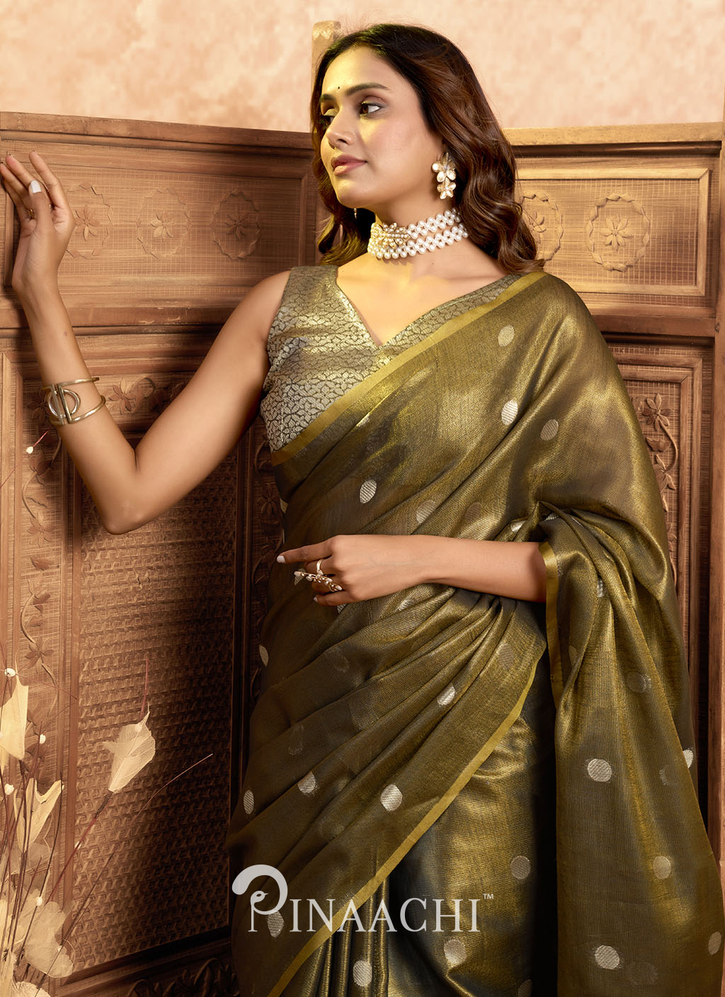 Pinaachi tissue silk saree online olive green saree with silver polka dots worn by model with silver jewelry