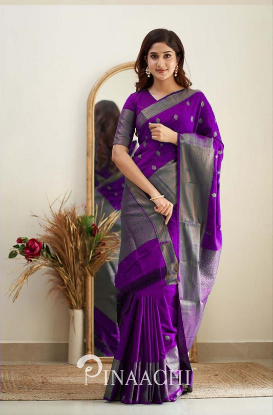 Woman wearing Pinaachi Violet Litchi Silk Saree with silver border and traditional design