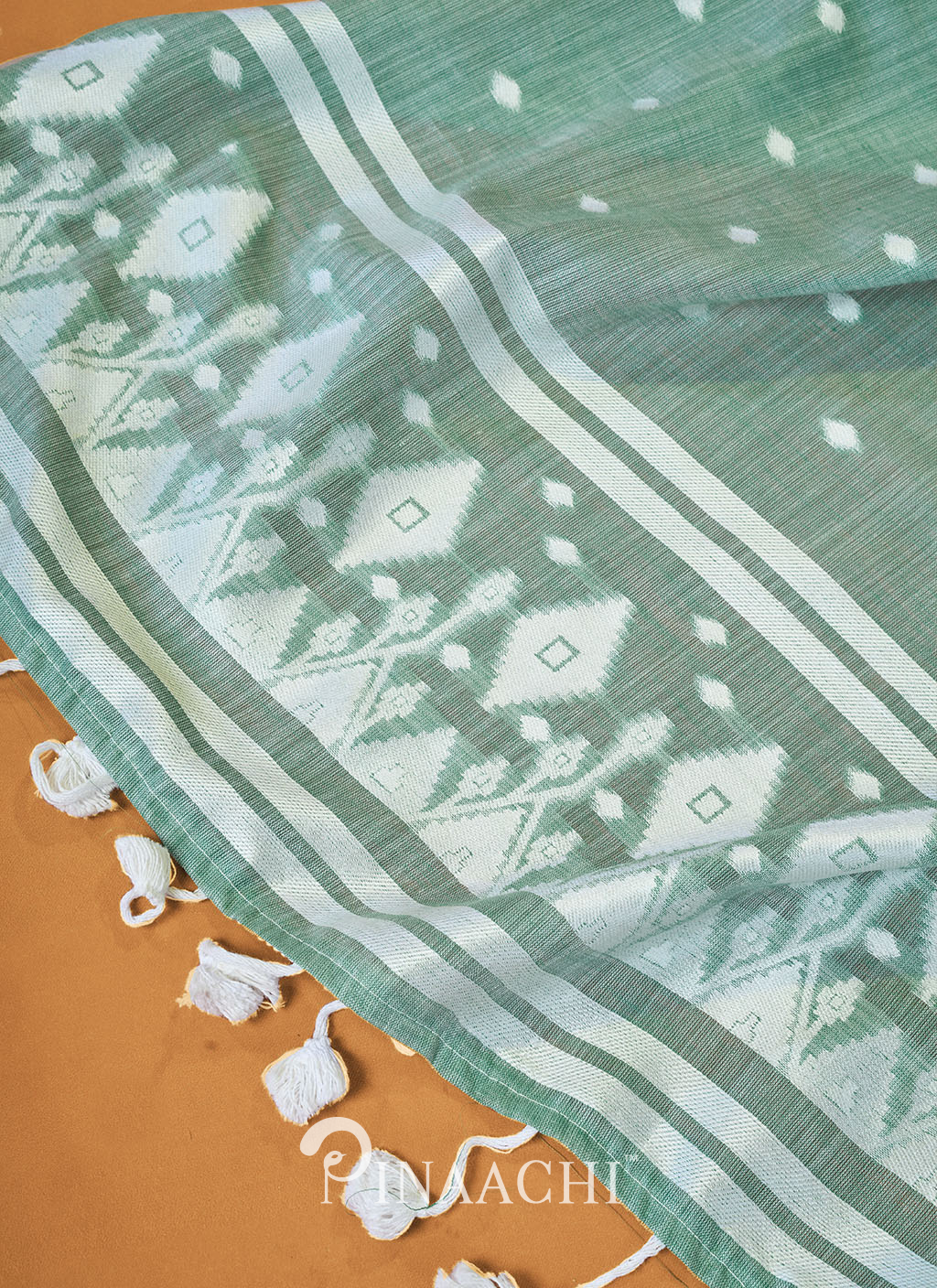 Pinaachi Rama Cotton Jamdani Saree in green with white geometric border and tassels