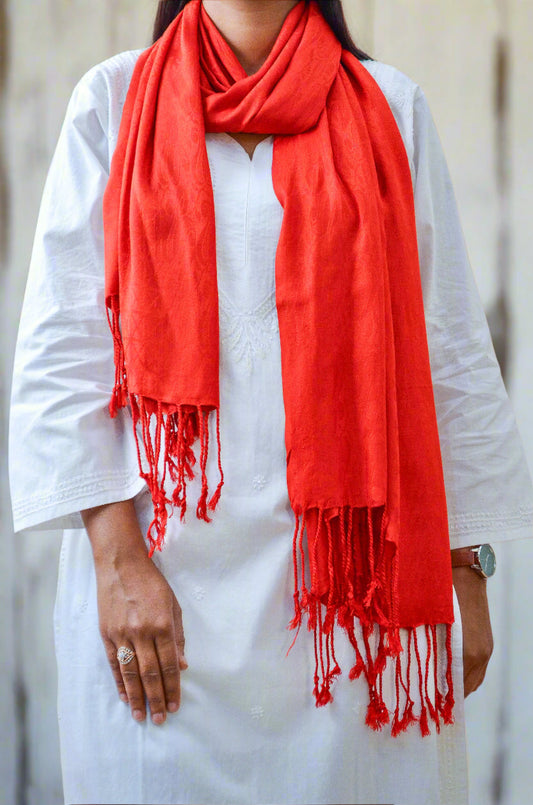 Stylish woman wearing a vibrant red jacquard stole for women, perfect for adding flair to any outfit