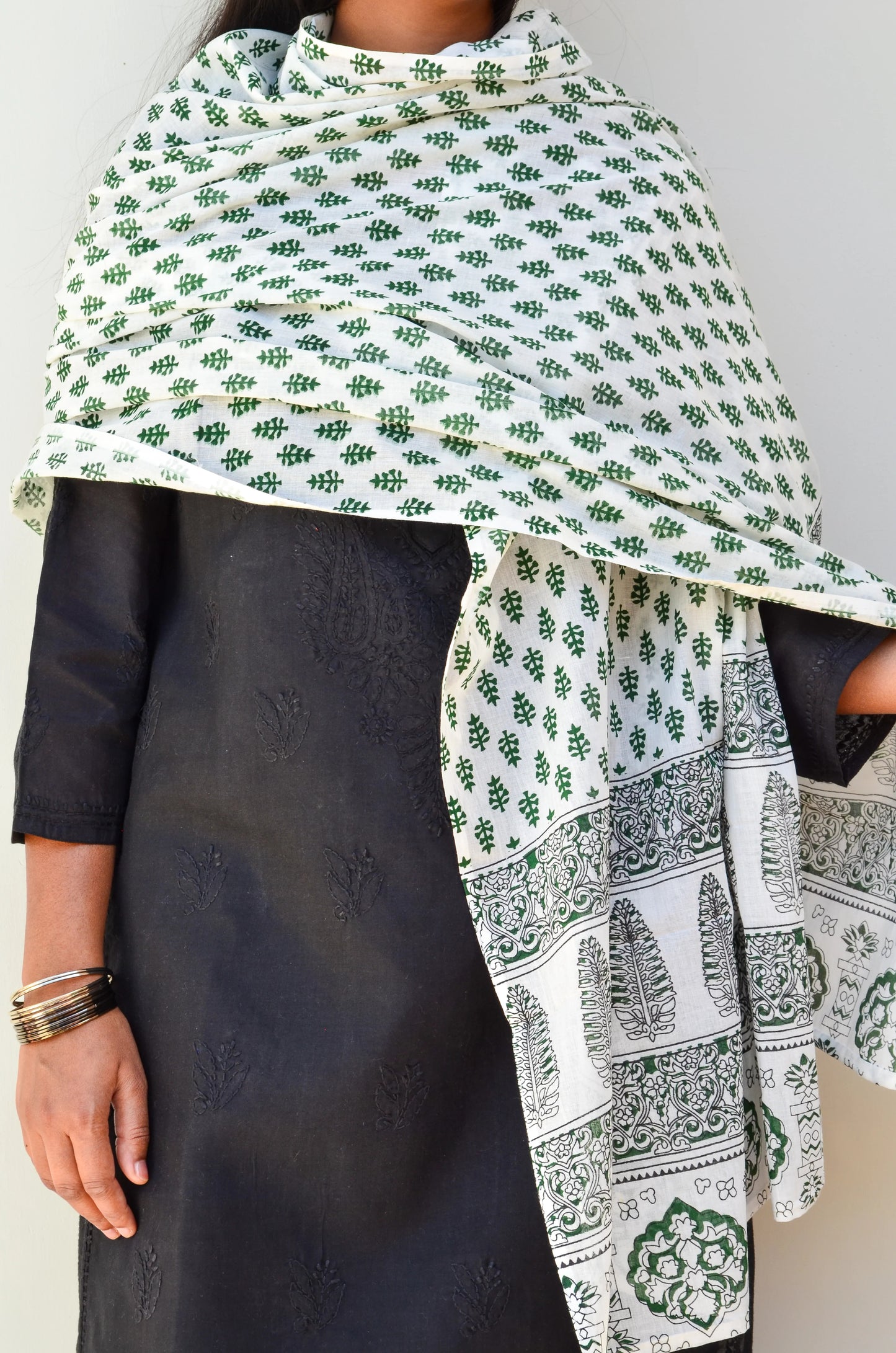 Sanganeri hand block printed dupatta in green and white draped elegantly over a black kurta